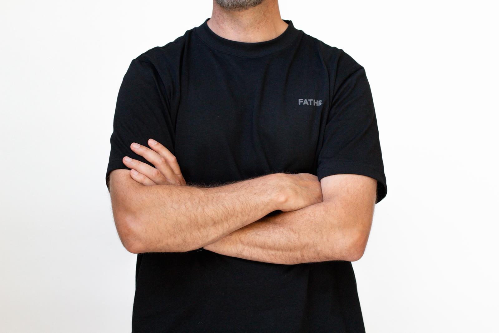 Father wearing a black t-shirt with 'FATHR' logo 