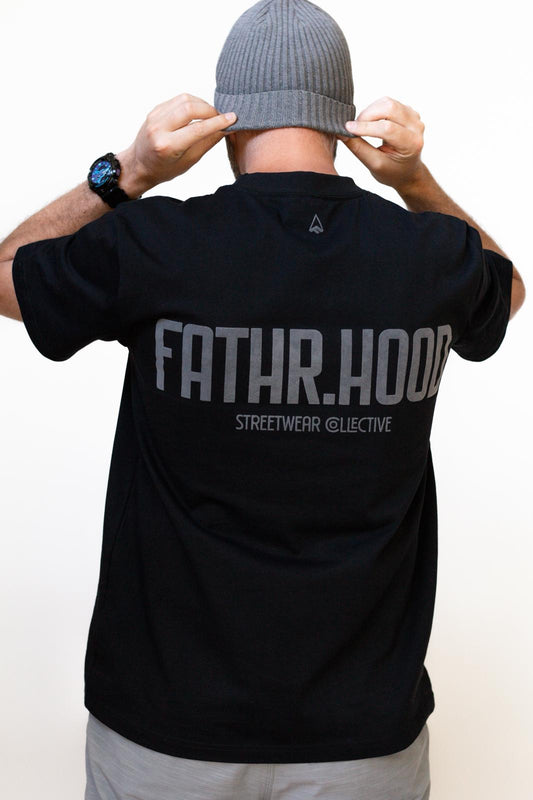 NZ Father wearing FATHR tee back view. adjusting beanie